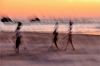 Walking_on_the_Beach_at_Sunset_by_Bert_Schmitz.jpg